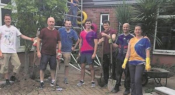 Some of the 100 volunteers from Merck working on refurbishing the Bishopstown school.