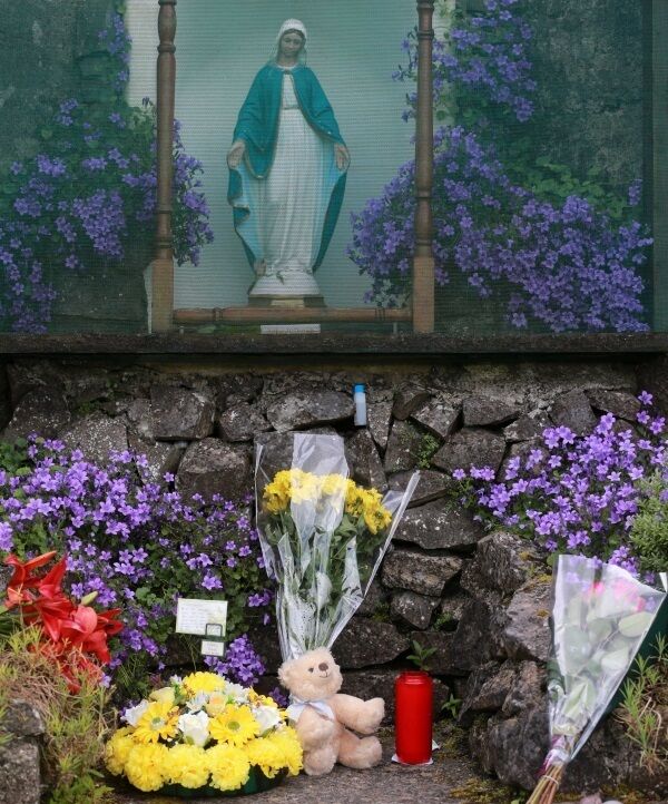 Flowers and tributes left in 2014 at the site of the unmarked mass grave containing the remains of nearly 800 infants who died at the Bon Secours mother-and-baby home in Tuam, Co Galway from 1925 1961.