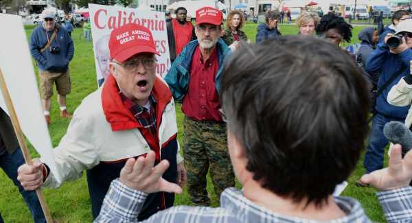 Trump supporter Jim Templeton, left, yells at an anti-Trump protester at a dual rally for and against President Donald Trump. Pic: Dan Honda/East Bay Times via AP