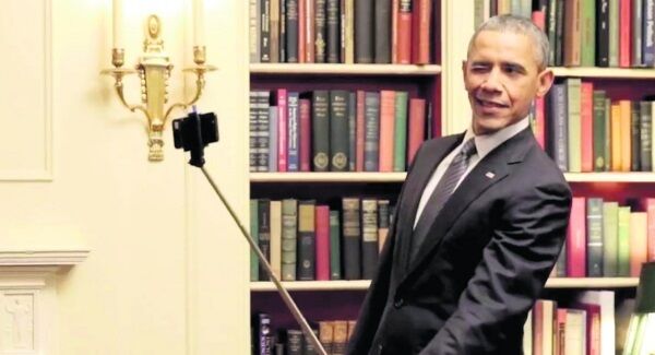 Barack Obama using a selfie stick. Barack Obama using a selfie stick.