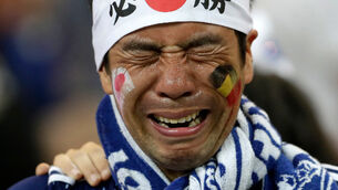Pics: Japan team leave dressing room spotless and crying fans clean stadium following defeat