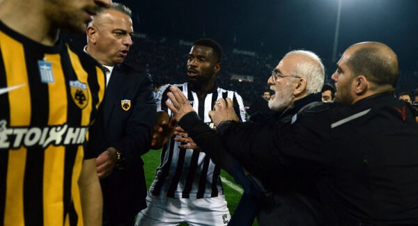 PAOK owner, businessman Ivan Savvidis, second right, approaches AEK Athens' Manager Operation Department Vassilis Dimitriadis, second left, as his bodyguard and PAOK's player Fernando Varela, centre, try to stop him. AP Photo PAOK owner, businessman Ivan Savvidis, second right, approaches AEK Athens' Manager Operation Department Vassilis Dimitriadis, second left, as his bodyguard and PAOK's player Fernando Varela, centre, try to stop him. AP Photo
