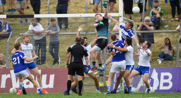 Rory Beggan of Monaghan clears possession despite the efforts by Kieran Lillis of Laois. Pic: Ramsey Cardy/Sportsfile Rory Beggan of Monaghan clears possession despite the efforts by Kieran Lillis of Laois. Pic: Ramsey Cardy/Sportsfile