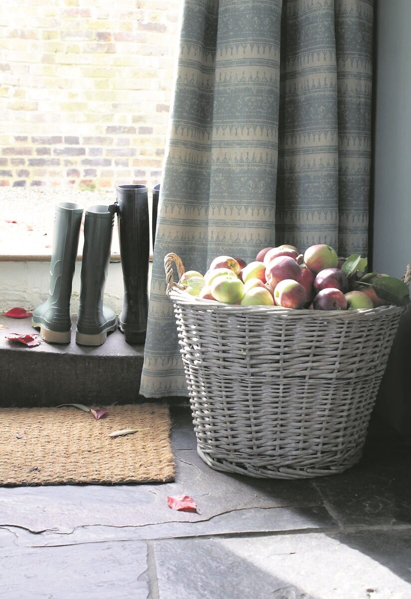 Curtains with thermal linings can cover doors and windows. Oxford linen heavily lined curtains on an exterior door, fabric, Tribal, by Julia Brendel, €64 per metre, juliabrendel.com.