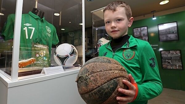 Luke McManus, 6, from Douglas, holding a football used in the 1926 Free State Cup Final between Fordson and Shamrock Rovers, comparing it with the modern ball on display at the FAI exhibition at St Peter’s, North Main St, Cork. Picture: Jim Coughlan