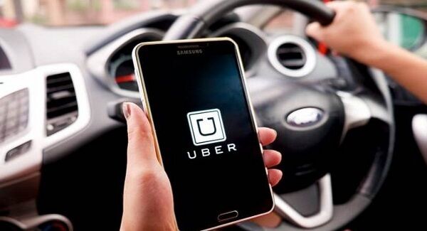 A driver using the Uber app. A driver using the Uber app.
