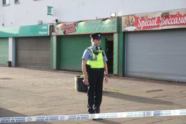 Garda at Edenmore Shopping Centre where two men were shot as they worked at Mizzoni take away, Two men are being held by Garda in connection with the shooting. Photo Garrett White.