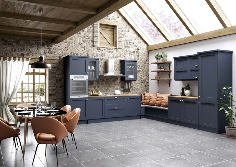 A run of in-frame traditional cabinets worked into a corner of an unremitting open-plan space plays the anti-kitchen. We love the reveal of the stone walling with careful addition of a few top cabinets. Note the clever teasing open and softening with seating, timber elements and a gentle touch of copper. Cash & Carry Savana in Marine Blue.