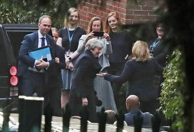 Theresa May, centre, is greeted as she arrives at Stormont on Wednesday morning (Brian Lawless/PA)