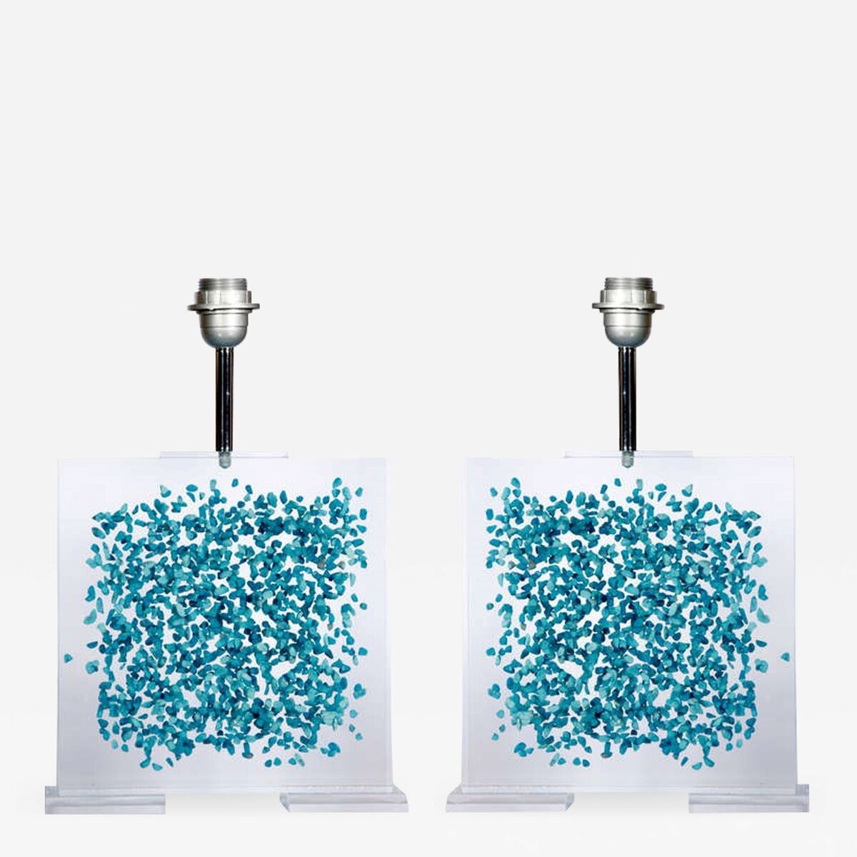 These lamps are from Romeo of Paris, who made a wide range of sophisticated lamp bases with inclusions from used artists paint tubes to semi-precious stones. Try 1stDibs for vintage examples from 1970 1979. 1stdibs.com.