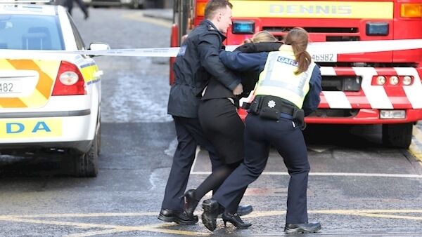 Gardaí helping a woman from a courthouse in Smithfield. Pic: Collins