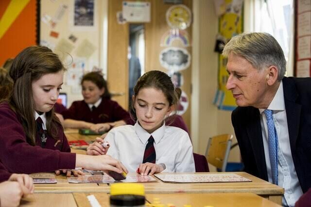 Mr Hammond visits a school in Moira, Co Down, on Friday (Liam McBurney/PA)