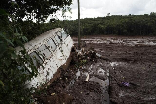 A van is seen in half buried in the mud (AP) A van is seen in half buried in the mud (AP)