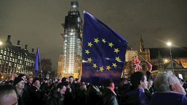 A person in the crowd holds an EU flag during a rally in London's Parliament Square as MPs considered the Prime Minister's Brexit deal. Picture: PA