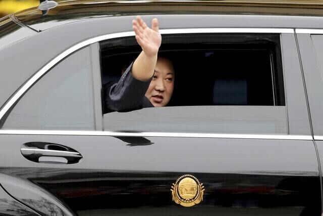 North Korean leader Kim Jong Un waves from a car  (Minh Hoang/AP)