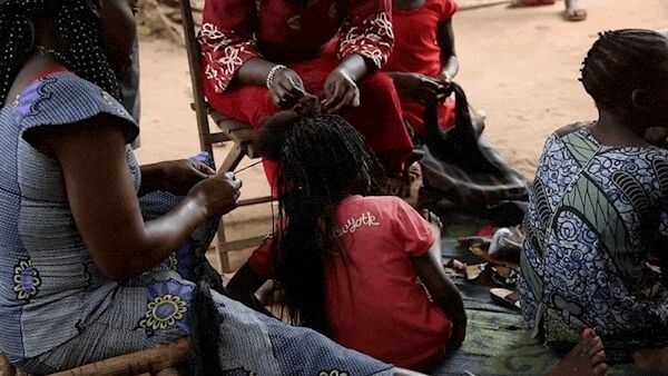 Women plait the hair of a former child soldier in Yambio, south Sudan. Picture: MSF