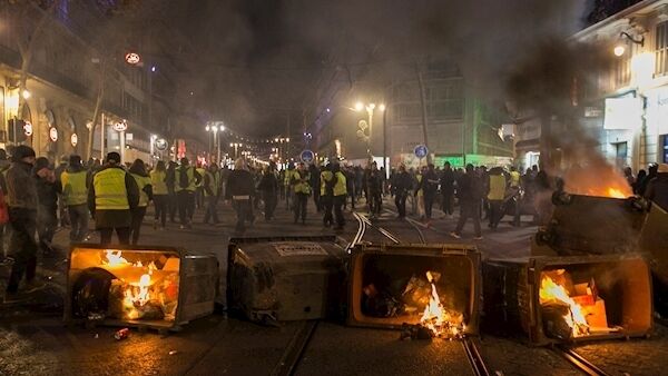 Yellow vest protestors barricade a street with burning garbage containers in Marseille, southern France, Saturday, Jan. 12, 2019. (AP Photo/Claude Paris) Yellow vest protestors barricade a street with burning garbage containers in Marseille, southern France, Saturday, Jan. 12, 2019. (AP Photo/Claude Paris)