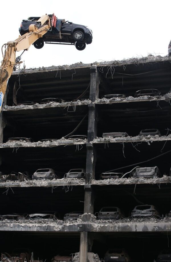 Burnt out cars are removed from their parking spaces as work began to demolish the multi-storey Liverpool Waterfront Car Park. Photo: Peter Byrne/PA Wire