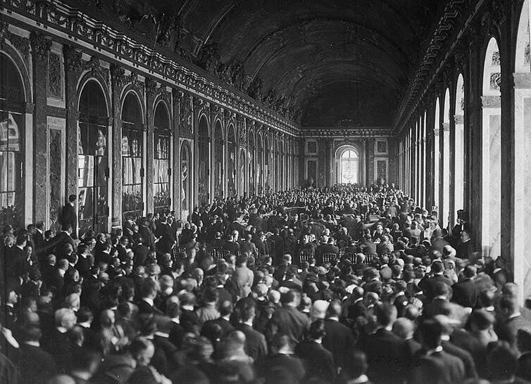 The delegations signing the Treaty of Versailles in the Hall of Mirrors. US National Archives