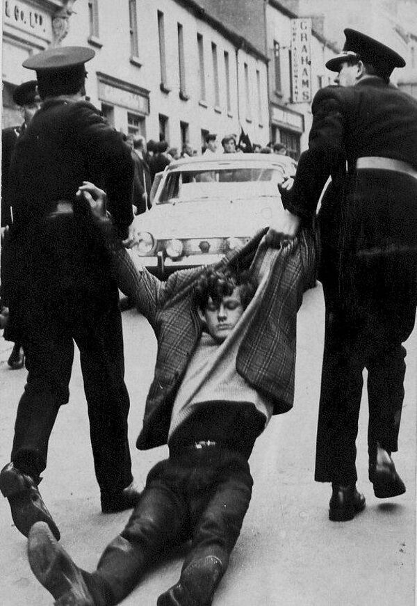 A young student is dragged away unconscious along Duke St after police attacked and refused the civil rights marchers to proceed across Craigavon Bridge, to the city centre.