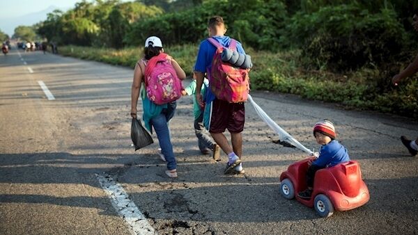Central American migrants traveling with a caravan to the U.S. make their way to Mapastepec, Mexico, Wednesday, Oct. 24, 2018. Thousands of Central American migrants renewed their hoped-for march to the United States on Wednesday, setting out before dawn with plans to travel another 45 miles (75 kilometers) of the more than 1,000 miles that still lie before them. (AP Photo/Rodrigo Abd)