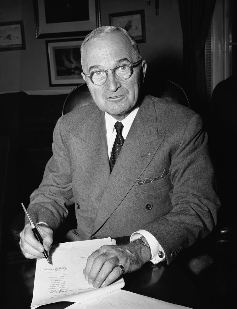 President Harry Truman in his White House office in Washington on Dec. 16, 1950 signs a proclamation of a state of national emergency, summoning the nation to marshal its strength against the threat of ‘Communist world conquest.’  AP Photo/William J. Smith