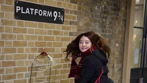 A Harry Potter fan at Platform 9¾ at Kings Cross station in London. A Harry Potter fan at Platform 9¾ at Kings Cross station in London.