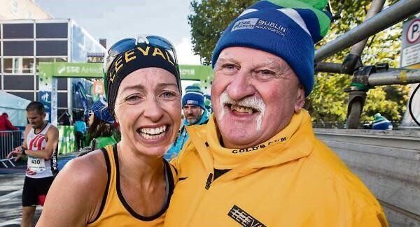 Leevale AC’s Lizzie Lee, with her coach Donie Walsh, after claiming the national title in yesterday’s Dublin City Marathon