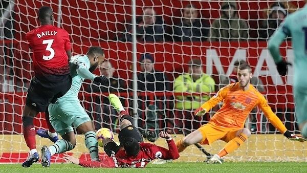 Arsenal's Alexandre Lacazette scores his side's second goal of the game during the Premier League match at Old Trafford. Photo: Martin Rickett/PA.