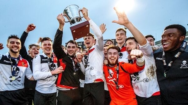 UCC's Daniel Pender and Robert Slevin lift the trophy. Picture: INPHO/James Crombie