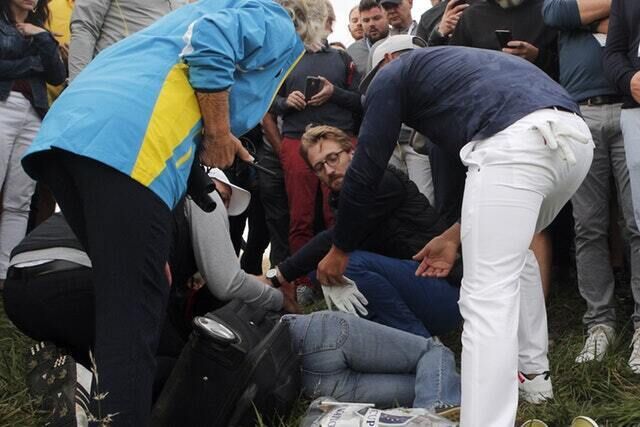 Brooks Koepka gives a glove to the injured spectator after the incident (Francois Mori/AP) Brooks Koepka gives a glove to the injured spectator after the incident (Francois Mori/AP)