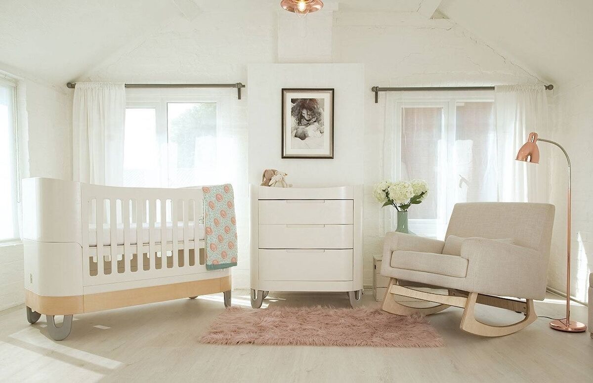 The Gaia Serena collection of nursery furniture grows with the child and includes a cot-to-bed system, a rocking chair and footstool, and storage with changing table. The Gaia Serena collection of nursery furniture grows with the child and includes a cot-to-bed system, a rocking chair and footstool, and storage with changing table.