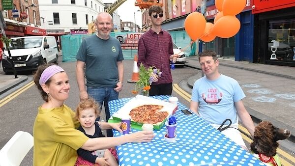 Organisers Alice Coyle with 1yo Evie and Kevin Smyth with (rear) Michael Creedon of Bradley's Off-Licence and Caoilian Sherlock of The Quarter Block Party relax on the street. The street is closed to vehicular traffic due to planned demolition works.