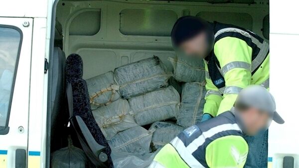 Gardaí loading the 55 bales of drugs into a garda van at Baltimore.