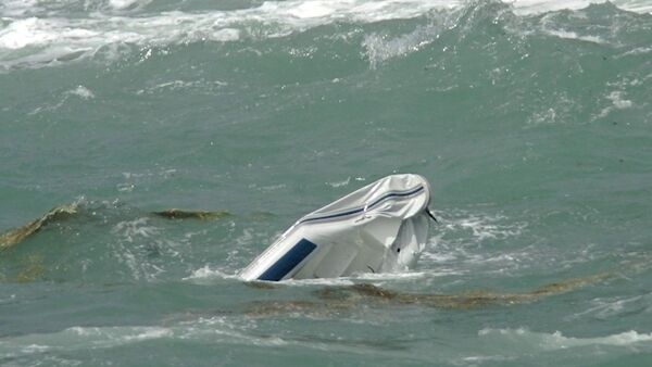 The remains of the ill fated rib floating partly submerged in the sea near Mizen Head.