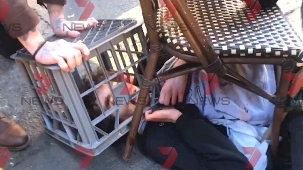 Screengrab taken with permission from a video issued by 7 News of a man being tackled with a milk crate and chairs by members of the public in Sydney, Australia, following a knife attack. Photo: Andrew Denney/7 News/PA.