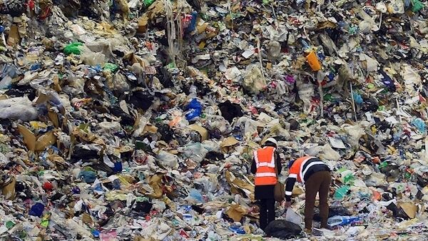 Visitors to the Panda Irish Packaging Recycling plant are dwarfed by an enormous mound of material collected from households in the Dublin area. Picture: Moya Nolan