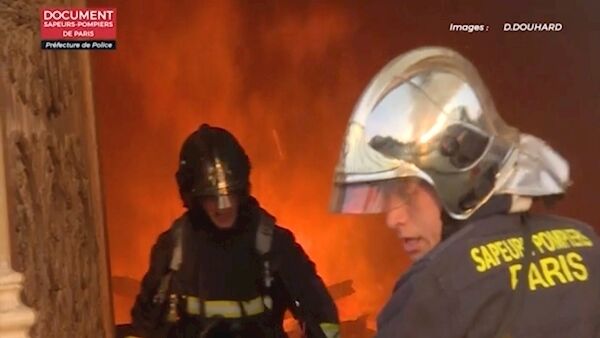 French firefighters battling the blaze, which broke out on Monday. Picture: Douhard/Paris Firefighters via AP