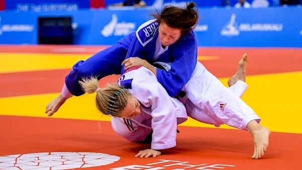 Megan Fletcher of Ireland, blue, in action against Sally Conway of Great Britain during their Women's Judo Middleweight preliminary round match at Chizhovka Arena on Day 3. Pic: Sportsfile