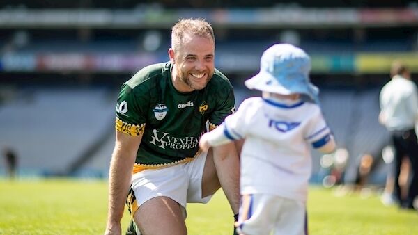 John Heneghan of the Australasia team with his 10-month-old son Séan on the Croke Park pitch. Picture: Morgan Treacy/inpho