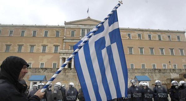 Greece aid faces delay as stiff austerity measures pass