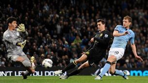 Thumper from Tevez fires City past Latics