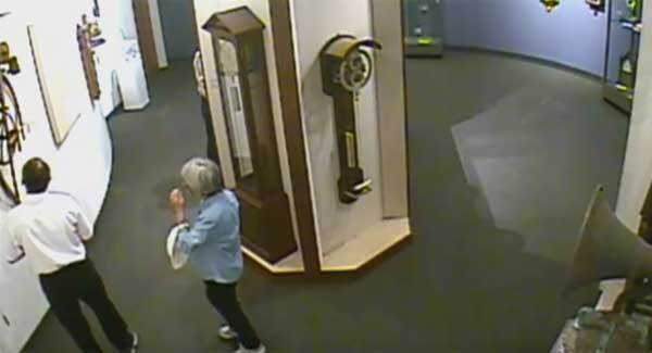 The excruciating moment a man accidentally pulls a priceless clock off a museum wall