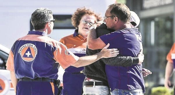 People are consoled by medic outside Hopital Pasteur in Nice, as nearly 20 people injured during the Bastille Day lorry attack remain in hospital in a life-threatening condition. Pic: Ben Birchall/PA