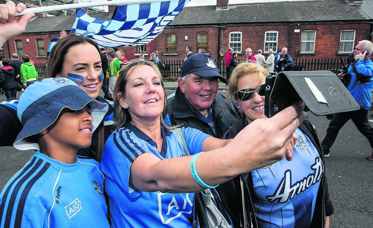 Dublin fans David Haughey and his son Tom, 7, from Castleknock, take time out as they support their team in the All-Ireland Senior Football Championship Final. Picture: James Crombie/Inpho