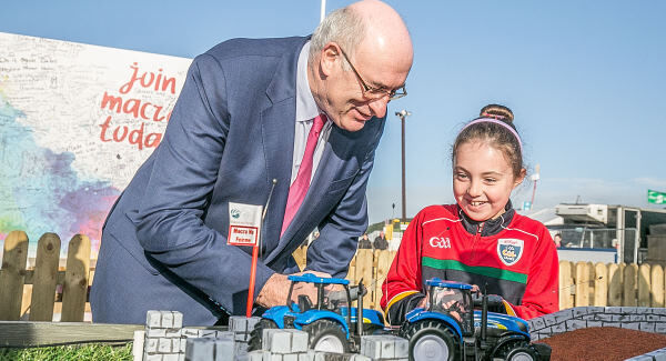 Seven year old Eva Nolan from Wexford was enjoying her day off from school by helping EU Agriculture Commissioner Phil Hogan gain control of a radio controlled tractor at the farm safety demo which is designed to teach children about the no go areas, dangers and sinage