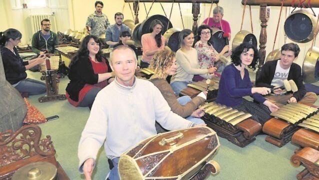The Cork ensemble banging a drum for gamelan in Ireland