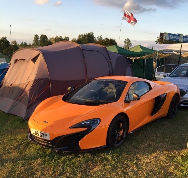 Camping in style. A McLaren 675LT parked by a tent at Porsche Curves