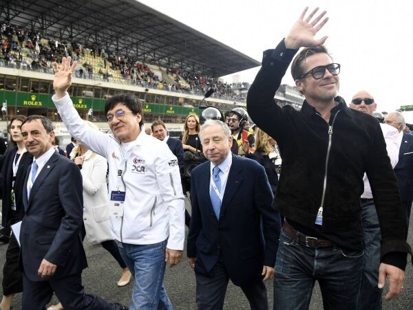 Actor Jackie Chan, FIA’s Endurance Commission, FIA president Jean Todt, and official race starter Brad Pitt wave before the 84th Le Mans 24-hours endurance race. Picture: Jean-Francois Monier/AFP/Getty Images