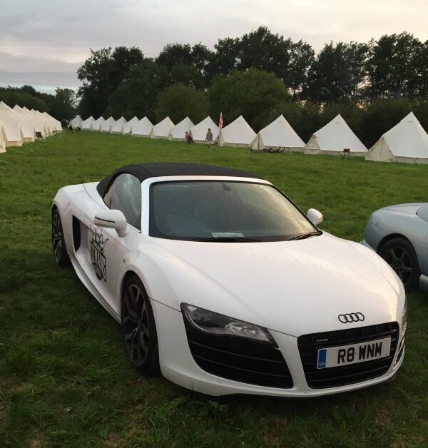 An Audi R8 parked at the campsite.